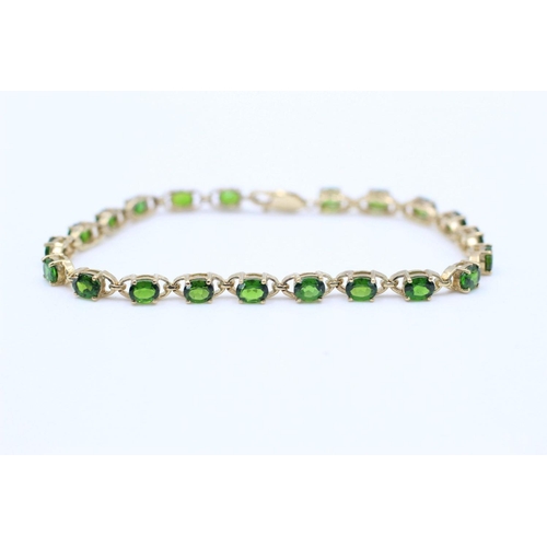 139 - 9ct gold Green gemstone line bracelet 9.5 grams gross