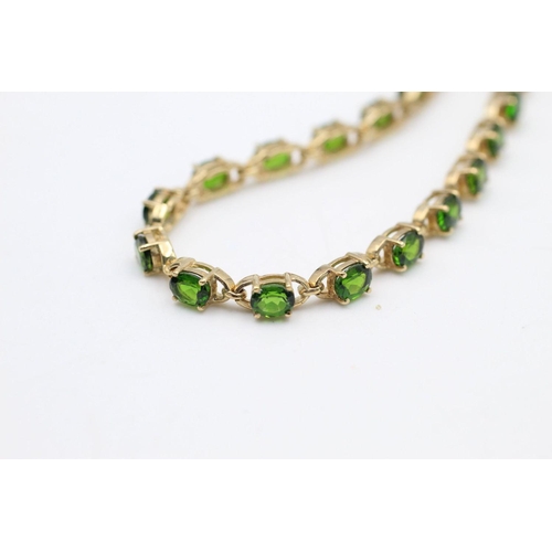 139 - 9ct gold Green gemstone line bracelet 9.5 grams gross