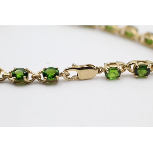 139 - 9ct gold Green gemstone line bracelet 9.5 grams gross