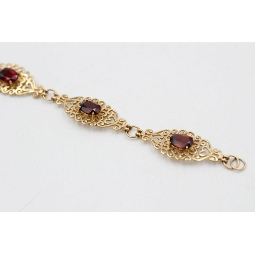 228 - 9ct Gold garnet detail ornate panel bracelet 7.9 grams gross