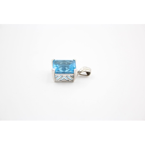 254 - 9ct White gold blue topaz pendant 5.6 grams gross