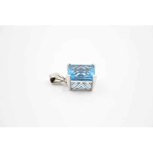 254 - 9ct White gold blue topaz pendant 5.6 grams gross