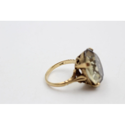 259 - 9ct gold Antique citrine dress ring with carved gallery and shoulders 7.5 grams gross