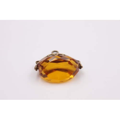 267 - 9ct Gold large orange paste spinner fob 9.3 grams gross