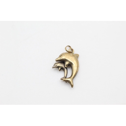 63 - 2 x 9ct gold dolphin pendants 1.1 grams gross