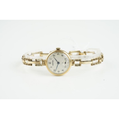 153 - LADIES VERTEX 9CT GOLD WRISTWATCH, circular silver dial with hour markers and hands, 24mm case with ... 