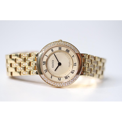 23 - LADIES 18CT GUCCI DIAMOND BEZEL WRIST WATCH, circular champagne dial with roman numeral hour markers... 
