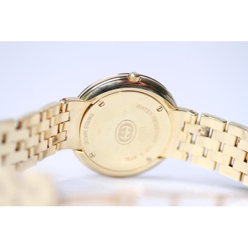 23 - LADIES 18CT GUCCI DIAMOND BEZEL WRIST WATCH, circular champagne dial with roman numeral hour markers... 