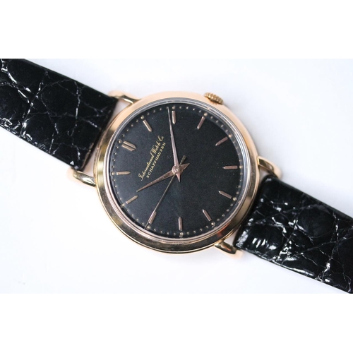 93 - VINTAGE 18CT IWC WRIST WATCH 1956, circular black dial with gold baton hour markers, 36mm 18ct gold ... 