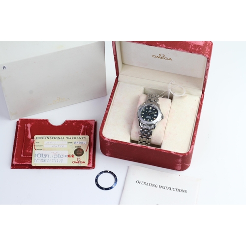 27 - OMEGA SEAMASTER MID-SIZE QUARTZ BOX AND PAPERS, circular blue wave dial with patina dot hour markers... 