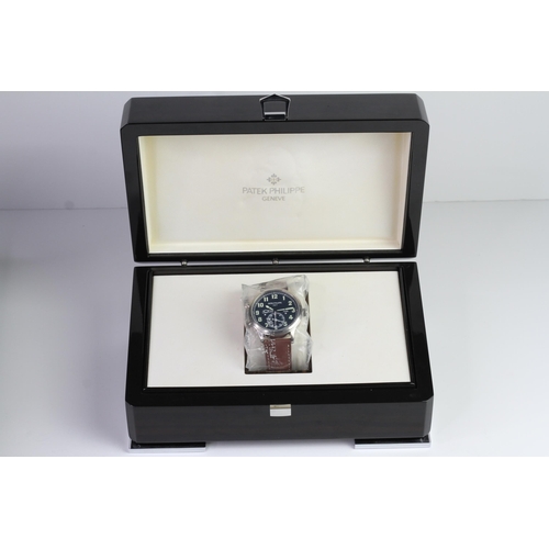 55 - A FINE PATEK PHILIPPE CALATRAVA PILOT TRAVEL TIME REFERENCE 5224G-001, SEALED FROM SERVICE, WITH BOX... 