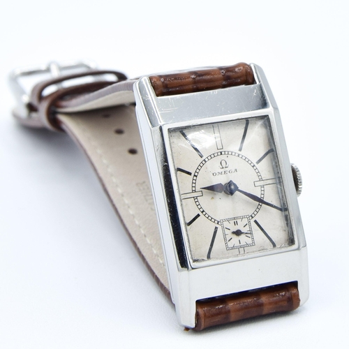 200 - OMEGA DECO STYLE TANK WRISTWATCH CALIBER 20F IN STAINLESS STEEL CASE CIRCA 1934 WITH SUNRISE DIAL. S... 