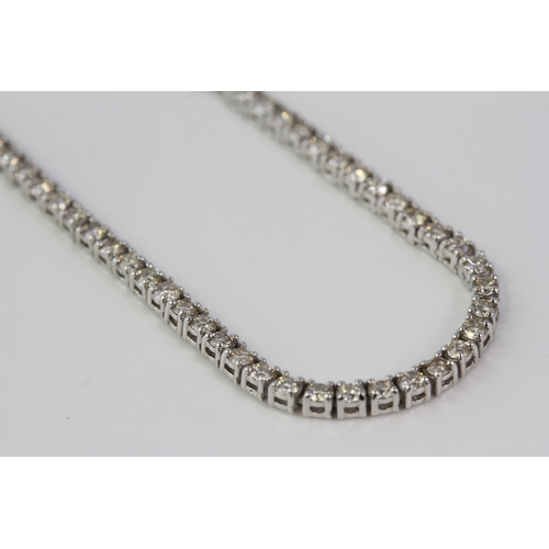 862 - In white gold a half diamond necklace, the front 21cm
(8 1/4 inches) set with diamonds. Fastened wit... 