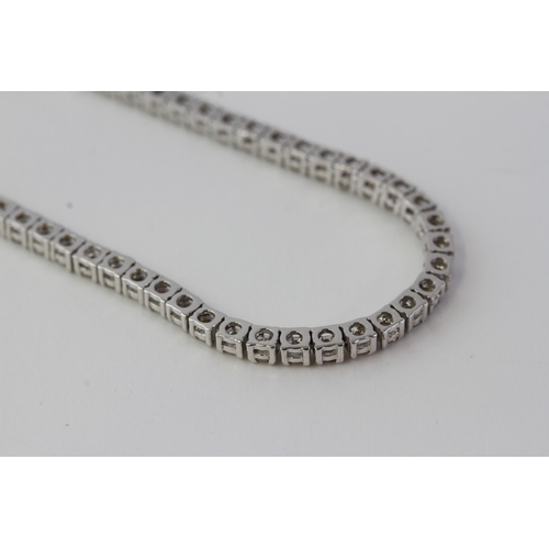 862 - In white gold a half diamond necklace, the front 21cm
(8 1/4 inches) set with diamonds. Fastened wit... 