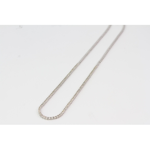 862 - In white gold a half diamond necklace, the front 21cm
(8 1/4 inches) set with diamonds. Fastened wit... 