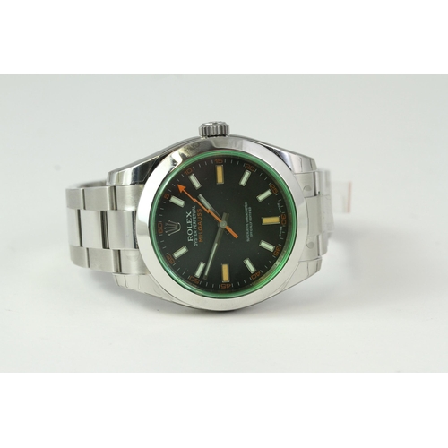 23 - UNWORN ROLEX MILGAUSS 116400GV BOX AND PAPERS, circular black dial with applied hour markers, orange... 