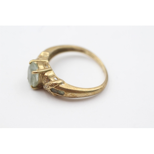 1083 - 9ct gold diamond & green gemstone ring (3.1g)