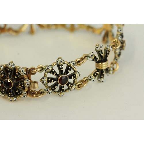 1505 - Fine 14ct gold and enamel Blackmore bracelet. Set with garnets in 14ct gold with black and white ena... 