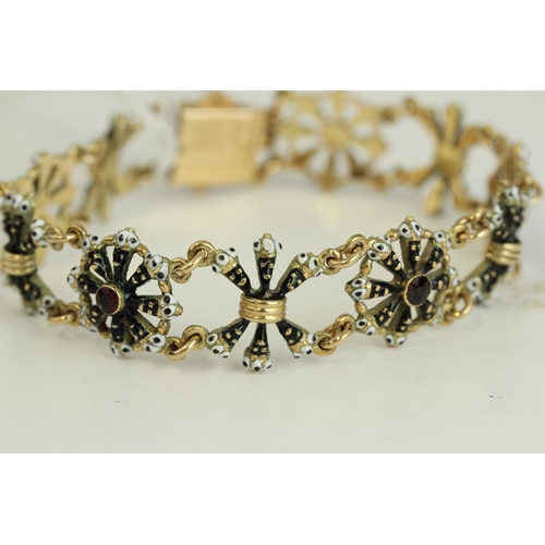 1505 - Fine 14ct gold and enamel Blackmore bracelet. Set with garnets in 14ct gold with black and white ena... 