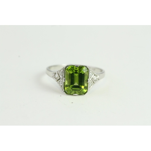 1522 - Platinum Peridot & Diamond Ring. Emerald cut Peridot is Claw-set Between Pave-set Diamond Kite Shoul... 