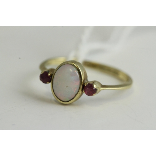 1135 - Fine 9ct gold opal and ruby ring, set in 9ct gold marked with a natural opal, flanked with a ruby ei... 