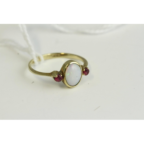 1135 - Fine 9ct gold opal and ruby ring, set in 9ct gold marked with a natural opal, flanked with a ruby ei... 