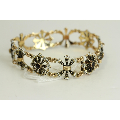 1505 - Fine 14ct gold and enamel Blackmore bracelet. Set with garnets in 14ct gold with black and white ena... 