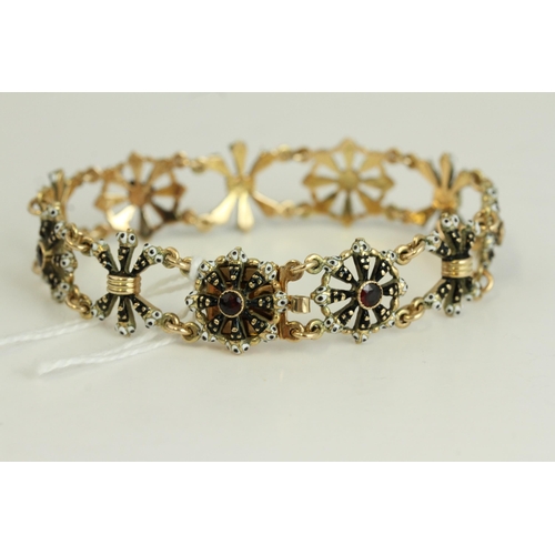 1505 - Fine 14ct gold and enamel Blackmore bracelet. Set with garnets in 14ct gold with black and white ena... 