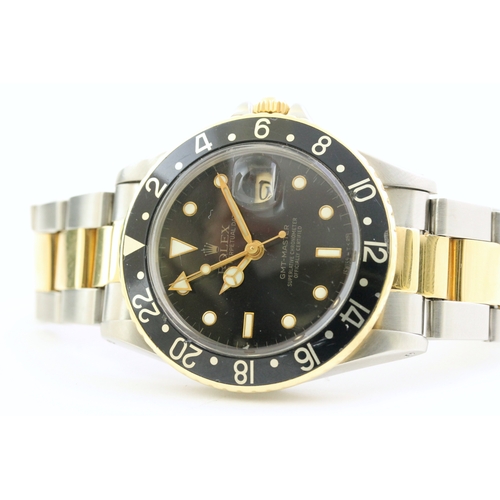 24 - VINTAGE ROLEX GMT MASTER 16753 STEEL AND GOLD CIRCA 1982, circular gloss black dial with mercedes ha... 