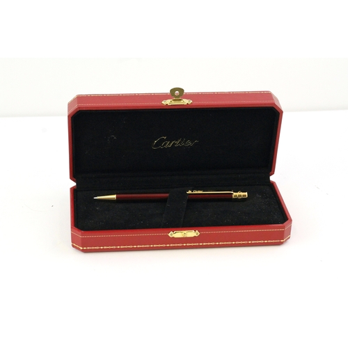 1022 - CARTIER BALLPOINT WITH BOX, red lacquer case, gold detail, with Cartier box, with presentation plaqu... 