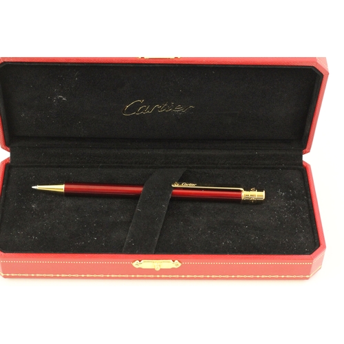 1022 - CARTIER BALLPOINT WITH BOX, red lacquer case, gold detail, with Cartier box, with presentation plaqu... 