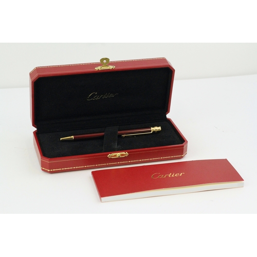 1023 - CARTIER BALLPOINT WITH BOX AND PAPERS, red lacquer case, gold detail, with Cartier box and paperwork... 