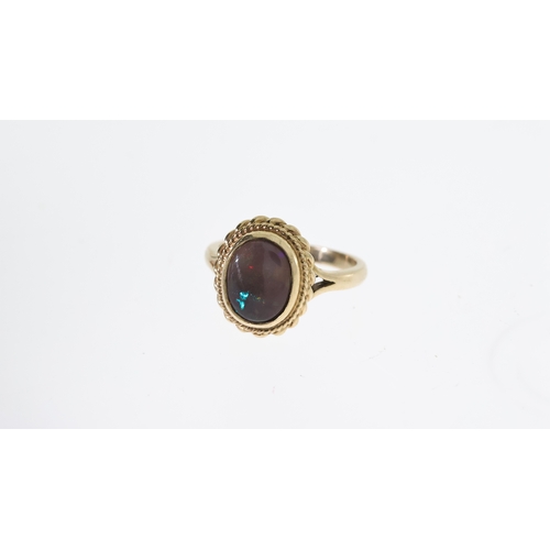 1294 - BLACK OPAL RING,  central oval cut cabochon black opal, approx 11x9mm, rope edge boarder, hallmarked... 