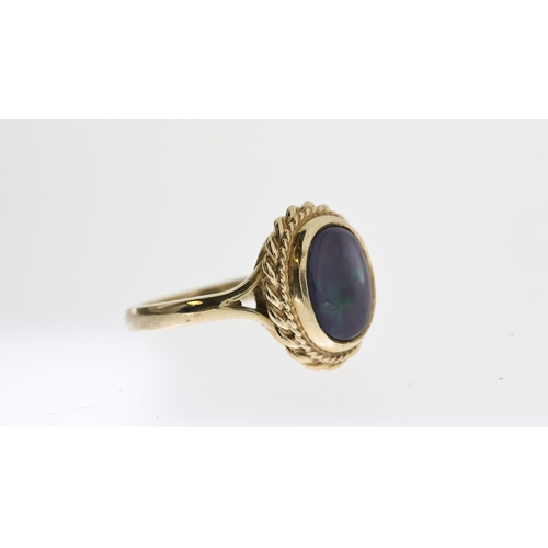 1294 - BLACK OPAL RING,  central oval cut cabochon black opal, approx 11x9mm, rope edge boarder, hallmarked... 