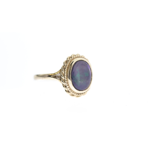 1294 - BLACK OPAL RING,  central oval cut cabochon black opal, approx 11x9mm, rope edge boarder, hallmarked... 