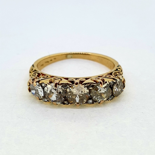 1010 - In 18 carat yellow gold a victorian carved 5 stone ring. The
diamonds are estimated to weigh 2.50 ca... 