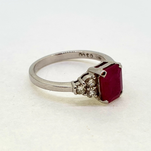 1012 - An emerald cut ruby ring with diamond shoulders.
Hallmarked 750