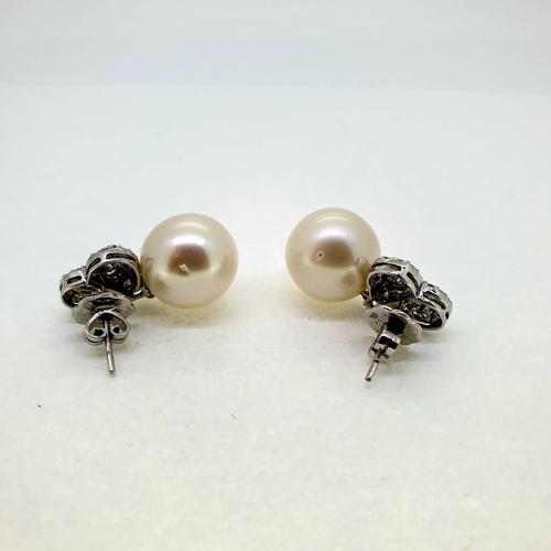 1013 - 12.5mm Southsea pearl and diamond earrings The Pearls
are suspended under a diamond heart of baguett... 