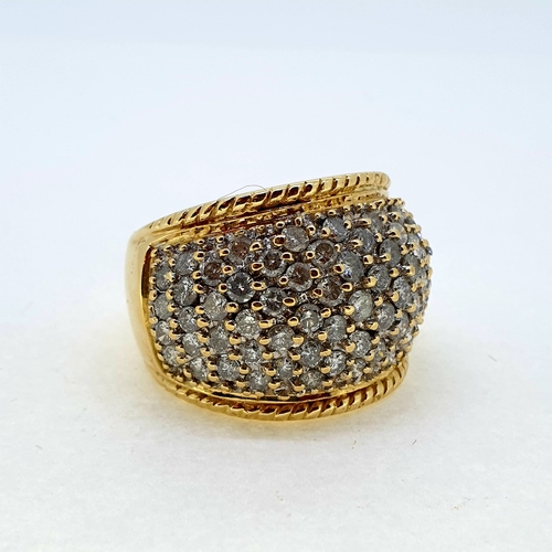 1015 - A yellow gold pave set diamond bombe ring. Marked 18K
and 750 Diamond weight estimated at 2.50 carat... 