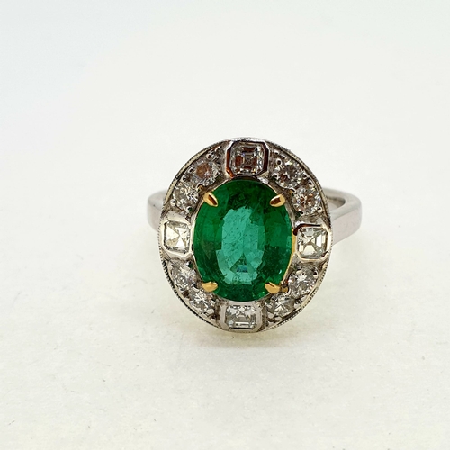 1020 - 18 carat white gold emerald and diamond cluster ring. A
nice bright oval emerald set with 4 gold cla... 