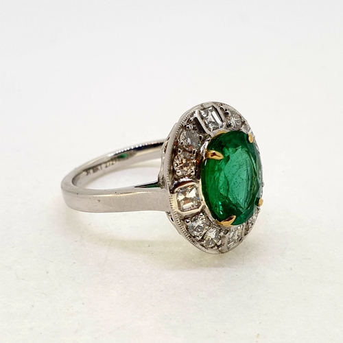 1020 - 18 carat white gold emerald and diamond cluster ring. A
nice bright oval emerald set with 4 gold cla... 