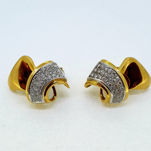 1021 - Yellow gold and diamond clip on earrings, circa 1940. The
diamonds are set in a three row taper in w... 