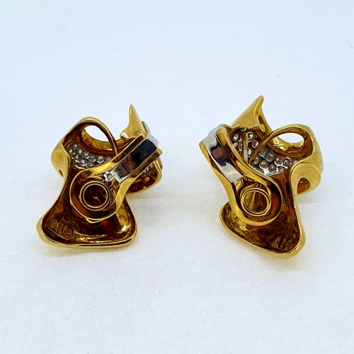 1021 - Yellow gold and diamond clip on earrings, circa 1940. The
diamonds are set in a three row taper in w... 