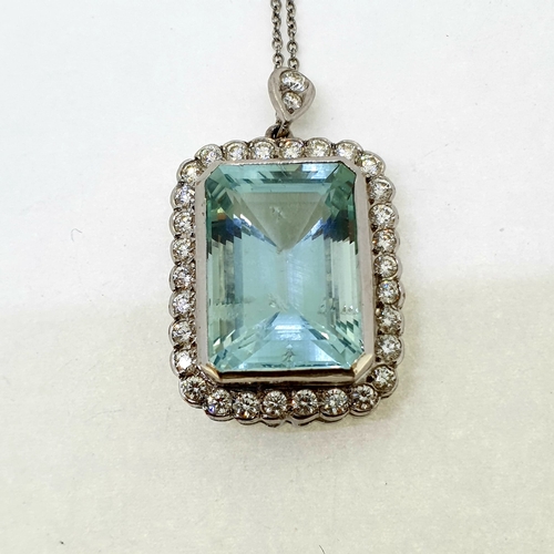 1022 - Emerald cut aquamarine in a diamond framed pendant with
diamond bale suspended on a 18 carat white g... 