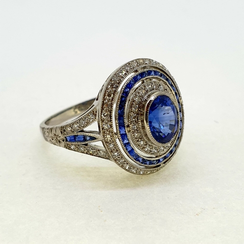 1025 - Platinum oval sapphire and diamond target ring with split
sapphire and diamond shoulders. Marked to ... 