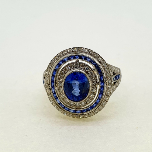 1025 - Platinum oval sapphire and diamond target ring with split
sapphire and diamond shoulders. Marked to ... 