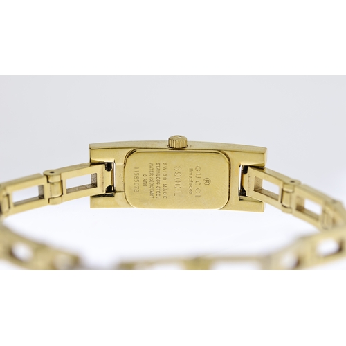 196 - LADIES GUCCI REF 3900L, approx 12mm champagne dial, gold plated bezel and case, Gucci crown, gold pl... 