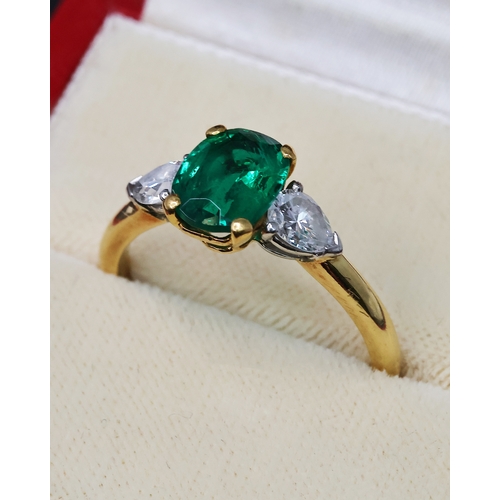 89 - CARTIER EMERALD AND DIAMOND RING, central oval cut emerald, flanked by a pair of pear cut diamonds, ... 