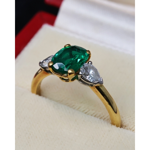 89 - CARTIER EMERALD AND DIAMOND RING, central oval cut emerald, flanked by a pair of pear cut diamonds, ... 