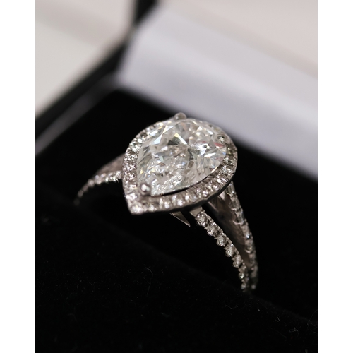 92 - FINE 2.34CT PEAR CUT DIAMOND CLUSTER RING, central pear cut diamond with a brilliant cut diamond boa... 